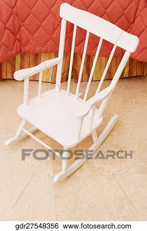 Rocking chair in the bedroom View Large Photo Image Stock Photograph - Rocking chair in the bedroom. Fotosearch