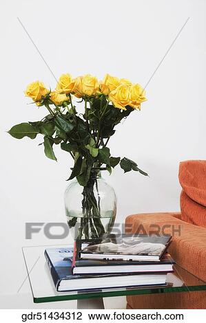 Rose flowers in a vase with books on a stool View Large Photo Image Stock Image - Rose flowers in a vase with books on a stool. Fotosearch