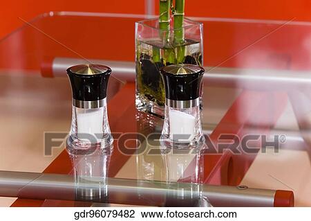 Salt shakers with a lucky bamboo on a table View Large Photo Image Stock Image - Salt shakers with a lucky bamboo on a table. Fotosearch