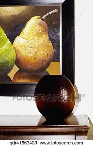 Showpiece on a sideboard with paintings View Large Photo Image Stock Photo - Showpiece on a sideboard with paintings. Fotosearch