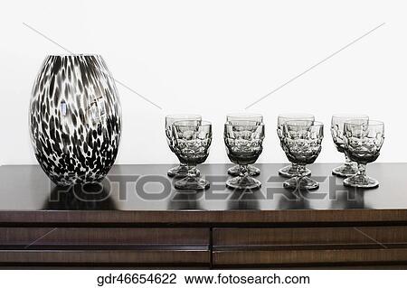 Showpiece with glasses on a sideboard View Large Photo Image Stock Image - Showpiece with glasses on a sideboard. Fotosearch