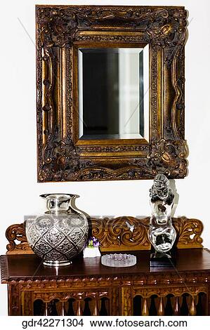 Showpieces On A Chest With Mirror In A Living Room Picture