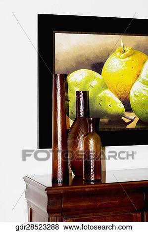 Showpieces on a sideboard with paintings View Large Photo Image Stock Photo - Showpieces on a sideboard with paintings. Fotosearch