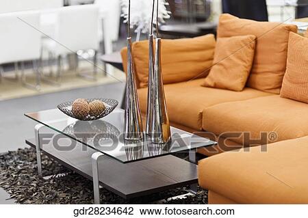 Stock Image - Showpieces on a table with a couch. Fotosearch