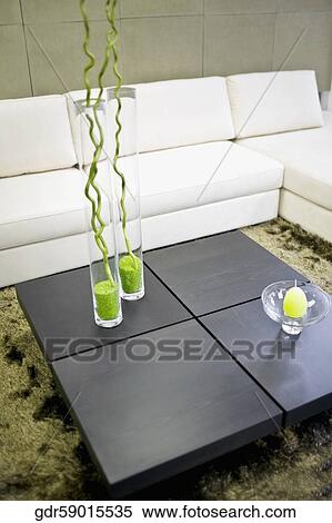 Stock Photography - Showpieces on a table with a couch. Fotosearch