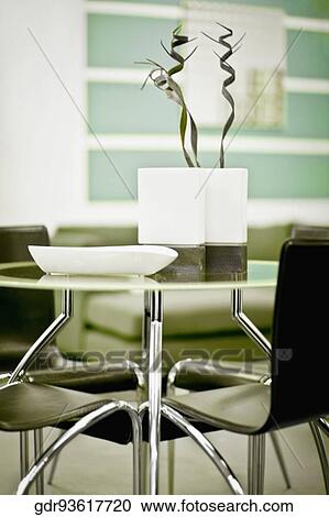 Stock Image - Showpieces on a table with chairs. Fotosearch