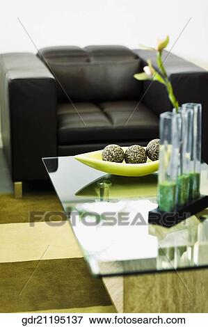 Stock Photo - Showpieces on a table with two seater sofa. Fotosearch
