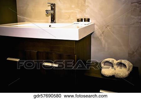 Slipper on a cabinet near a washbasin View Large Photo Image Stock Image - Slipper on a cabinet near a washbasin. Fotosearch