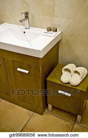 Stock Photograph - Slipper on a cabinet near a washbasin. Fotosearch
