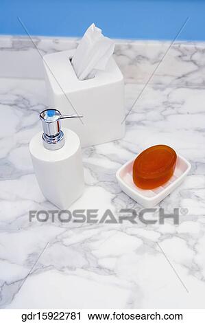 Soap dispenser and a bar of soap with tissue papers in the bathroom View Large Photo Image Stock Image - Soap dispenser and a bar of soap with tissue papers in the bathroom. Fotosearch