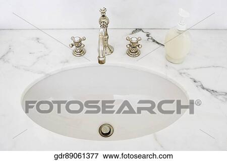 Soap dispenser on a bathroom sink View Large Photo Image Stock Photo - Soap dispenser on a bathroom sink. Fotosearch