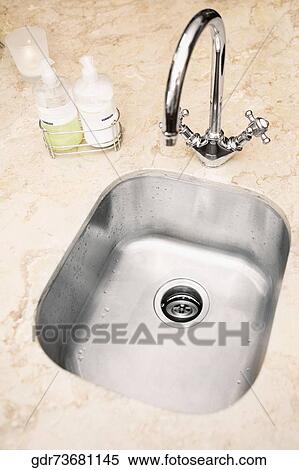Stainless steel sink with arched tap View Large Photo Image Stock Photography - Stainless steel sink with arched tap. Fotosearch