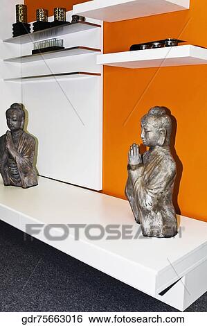 Statues of Buddha on a table View Large Photo Image Stock Photograph - Statues of Buddha on a table. Fotosearch