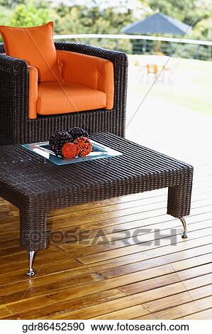 Table and an armchair on the patio View Large Photo Image Stock Image - Table and an armchair on the patio. Fotosearch