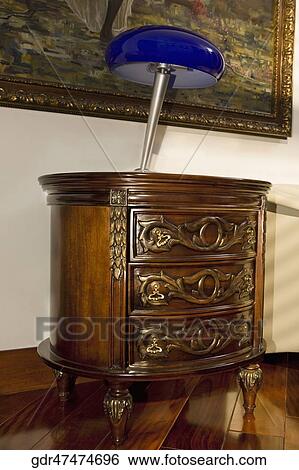 Table lamp on a side table View Large Photo Image Stock Photograph - Table lamp on a side table. Fotosearch