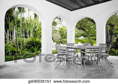 Stock Image - Table with chairs in a patio. Fotosearch