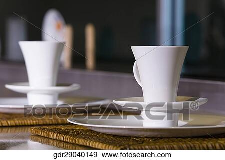 Tea cups with saucers on a table View Large Photo Image Stock Photo - Tea cups with saucers on a table. Fotosearch