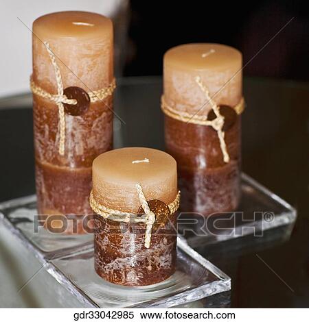 Three candles on a table View Large Photo Image Stock Photography - Three candles on a table. Fotosearch