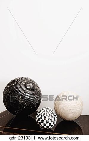 Three decorative balls on a chest View Large Photo Image Stock Image - Three decorative balls on a chest. Fotosearch