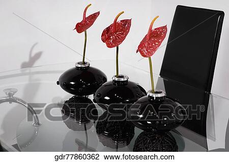 Stock Image - Three vases on a dining table. Fotosearch