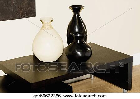 Three vases on a sideboard View Large Photo Image Stock Photograph - Three vases on a sideboard. Fotosearch
