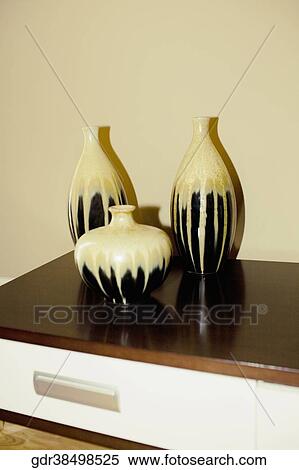 Three vases on a sideboard View Large Photo Image Stock Photography - Three vases on a sideboard. Fotosearch