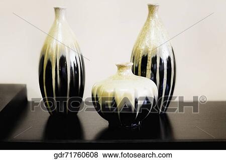 Three vases on a table View Large Photo Image Stock Photo - Three vases on a table. Fotosearch