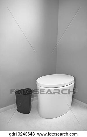 Stock Image - Toilet and a waste container in the bathroom. Fotosearch