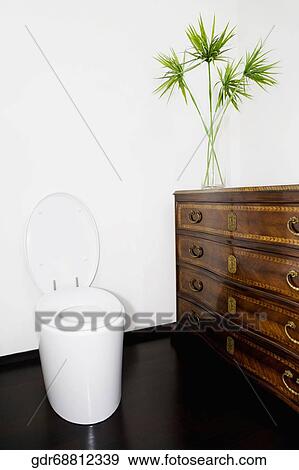 Stock Photo - Toilet bowl and cabinet in the bathroom. Fotosearch