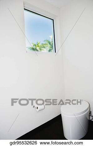 Stock Photograph - Toilet bowl and toilet paper in the bathroom. Fotosearch