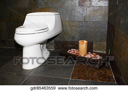 Toilet bowl with a candle in the bathroom View Large Photo Image Stock Photo - Toilet bowl with a candle in the bathroom. Fotosearch