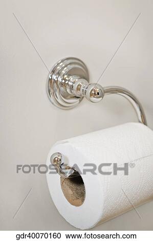 Stock Image - Toilet paper roll on a holder. Fotosearch
