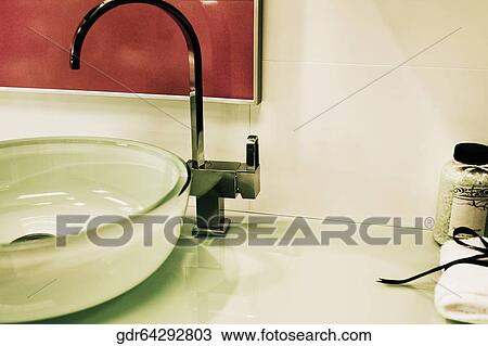 Toiletries near a faucet on a wash bowl View Large Photo Image Stock Image - Toiletries near a faucet on a wash bowl. Fotosearch