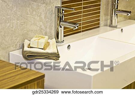 Toiletries near a faucet on a wash bowl View Large Photo Image Stock Photo - Toiletries near a faucet on a wash bowl. Fotosearch