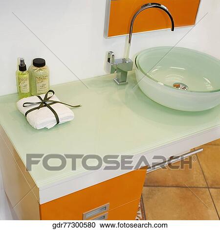 Toiletries near a wash bowl on a cabinet View Large Photo Image Stock Image - Toiletries near a wash bowl on a cabinet. Fotosearch