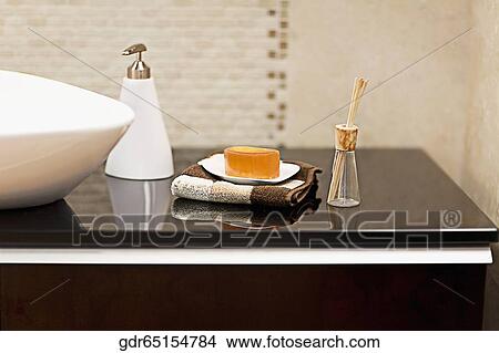 Picture - Toiletries near a wash bowl. Fotosearch