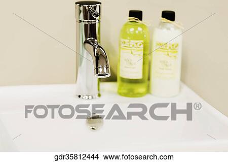 Toiletries on a bathroom sink View Large Photo Image Picture - Toiletries on a bathroom sink. Fotosearch