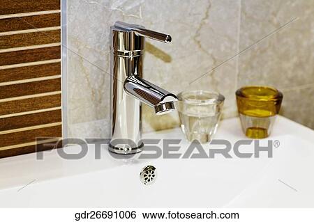 Toiletries on a bathroom sink View Large Photo Image Stock Photograph - Toiletries on a bathroom sink. Fotosearch