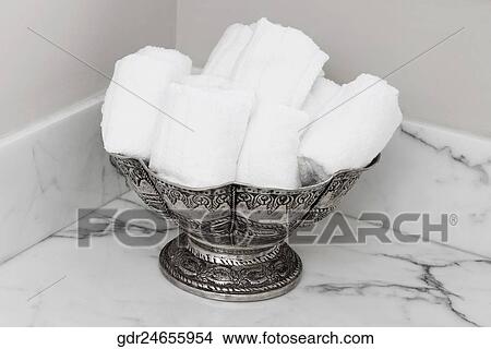 Picture - Towels in a container in the bathroom. Fotosearch