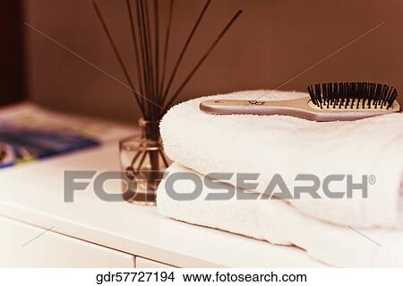 Towels with hairbrush on a cabinet in the bathroom View Large Photo Image Picture - Towels with hairbrush on a cabinet in the bathroom. Fotosearch