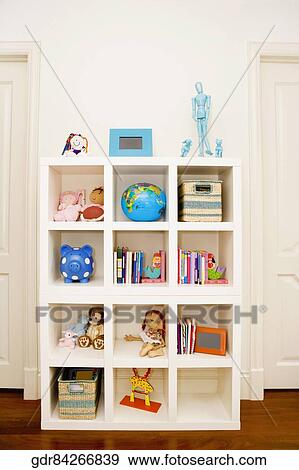 Stock Photo - Toys and books in a shelf. Fotosearch