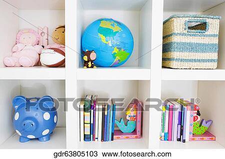 Stock Image - Toys and books on a shelf. Fotosearch