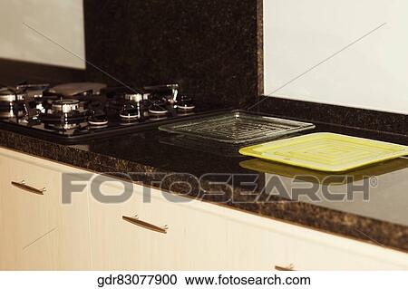 Tray near a stove in the kitchen View Large Photo Image Stock Image - Tray near a stove in the kitchen. Fotosearch