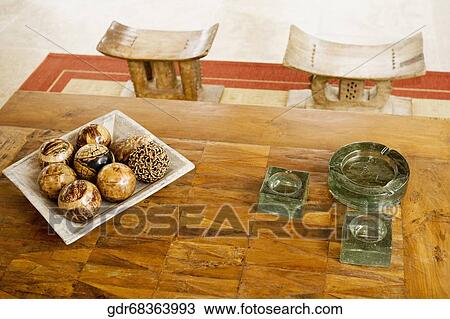 Stock Image - Tray of decorative balls and ashtrays on a table. Fotosearch