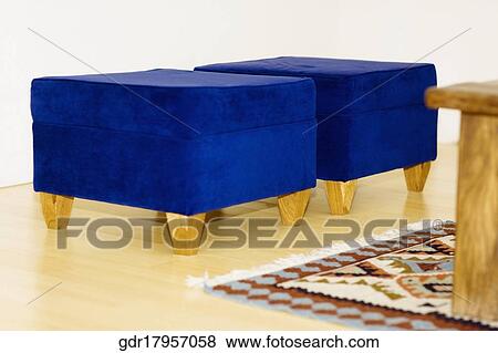 Stock Photo - Two blue ottomans in a living room. Fotosearch