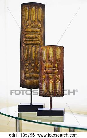 Two showpieces on a glass table View Large Photo Image Stock Photograph - Two showpieces on a glass table. Fotosearch