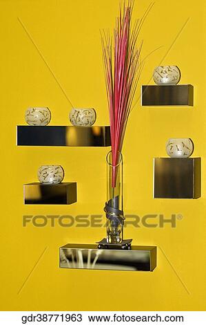 Stock Image - Vase and candles on racks. Fotosearch