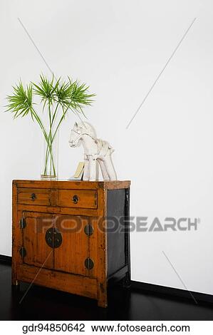 Vase and figurine on a wooden cabinet View Large Photo Image Stock Image - Vase and figurine on a wooden cabinet. Fotosearch