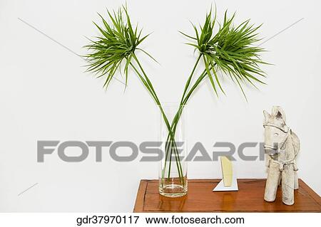 Vase and figurine on a wooden cabinet View Large Photo Image Stock Photo - Vase and figurine on a wooden cabinet. Fotosearch