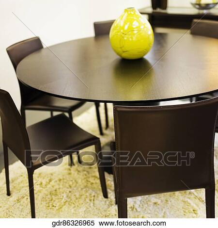 Vase on a dining table View Large Photo Image Stock Photography - Vase on a dining table. Fotosearch